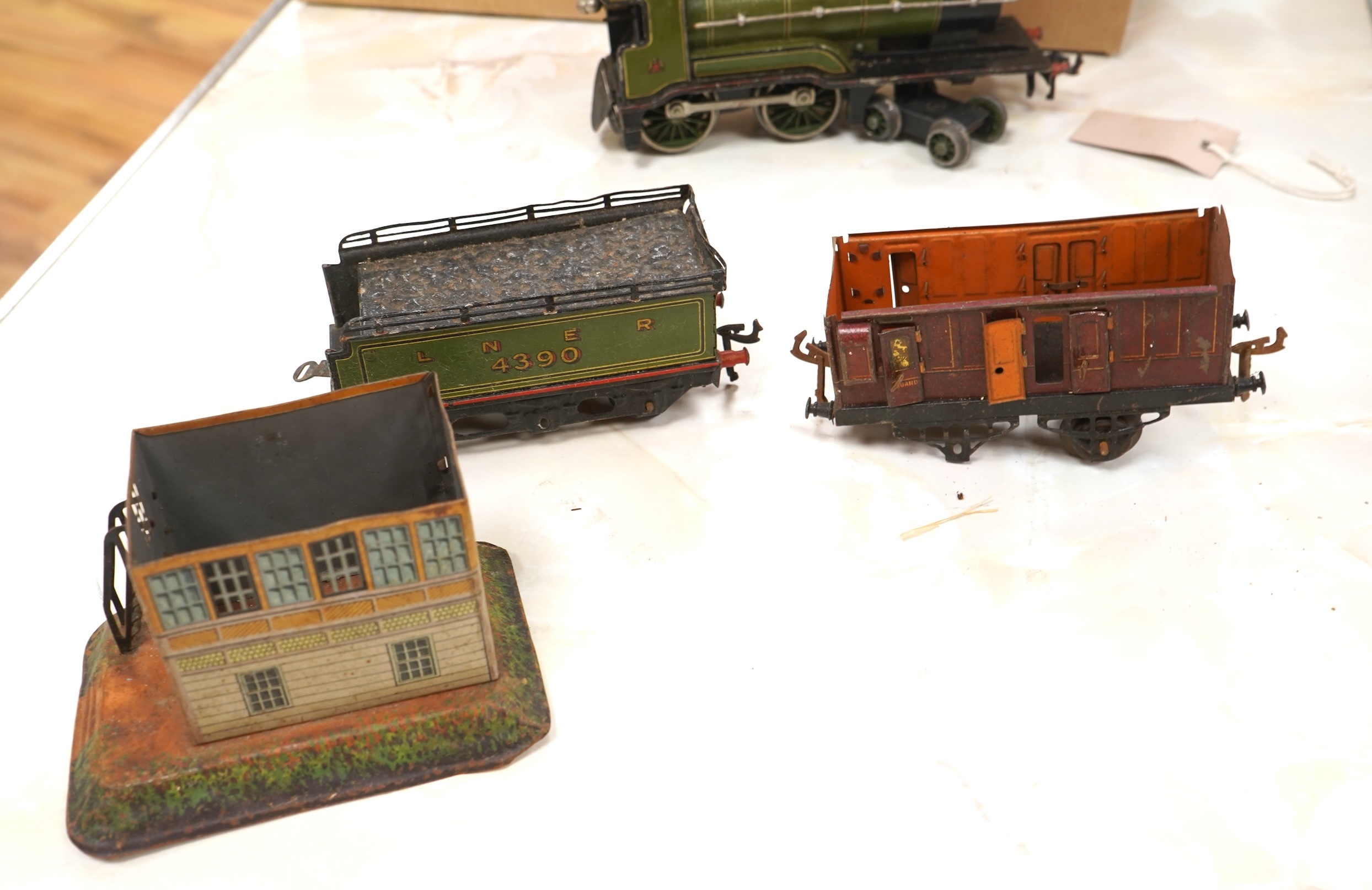 A Bing for Bassett Lowke 0 gauge tinplate clockwork LNER Ivatt 4-4-0 tender locomotive, 4390, together with an early Hornby clockwork 0-4-0, 2710, in GNR green livery with Meccano Ltd roundels to locomotive splasher and